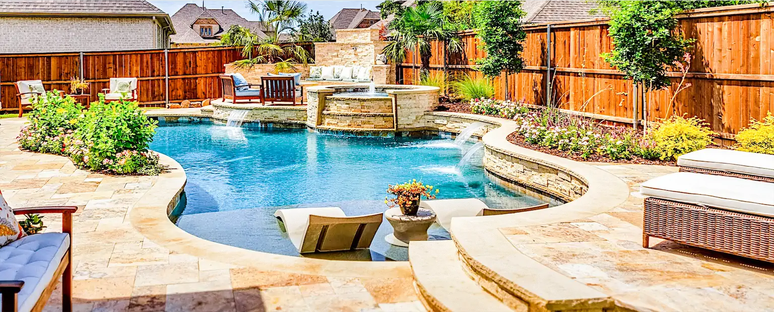 custom pool with features that include stacked stone water feature, waterfall, spa spillway, and rock landscaping by ogden pools in Memphis, TN