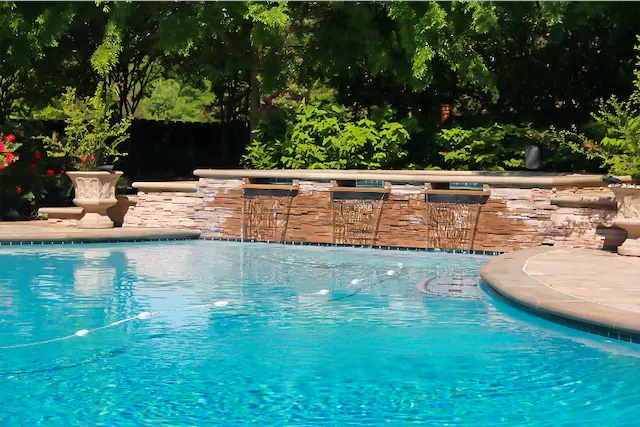 custom gunite swimming pool with water features that includes cascades and spa spillways by ogden pools in memphis, tn