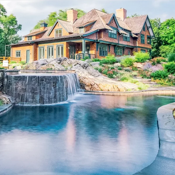 custom pool with features that include stacked stone water feature, waterfall, rock landscaping by ogden pools in Memphis, TN