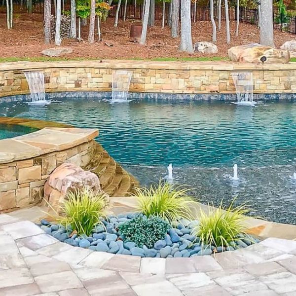 memphis pool renovation company project with addition of water features that include cascades, fountains, spa spillway, and stacked stone wall