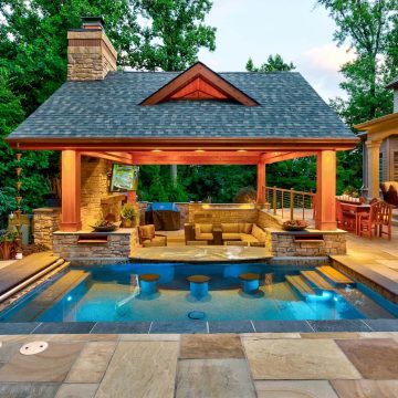 memphis swimming pool remodeling with custom swim up bar and built-in bar stools attached to an outdoor pergola by ogden pools in memphis, tn